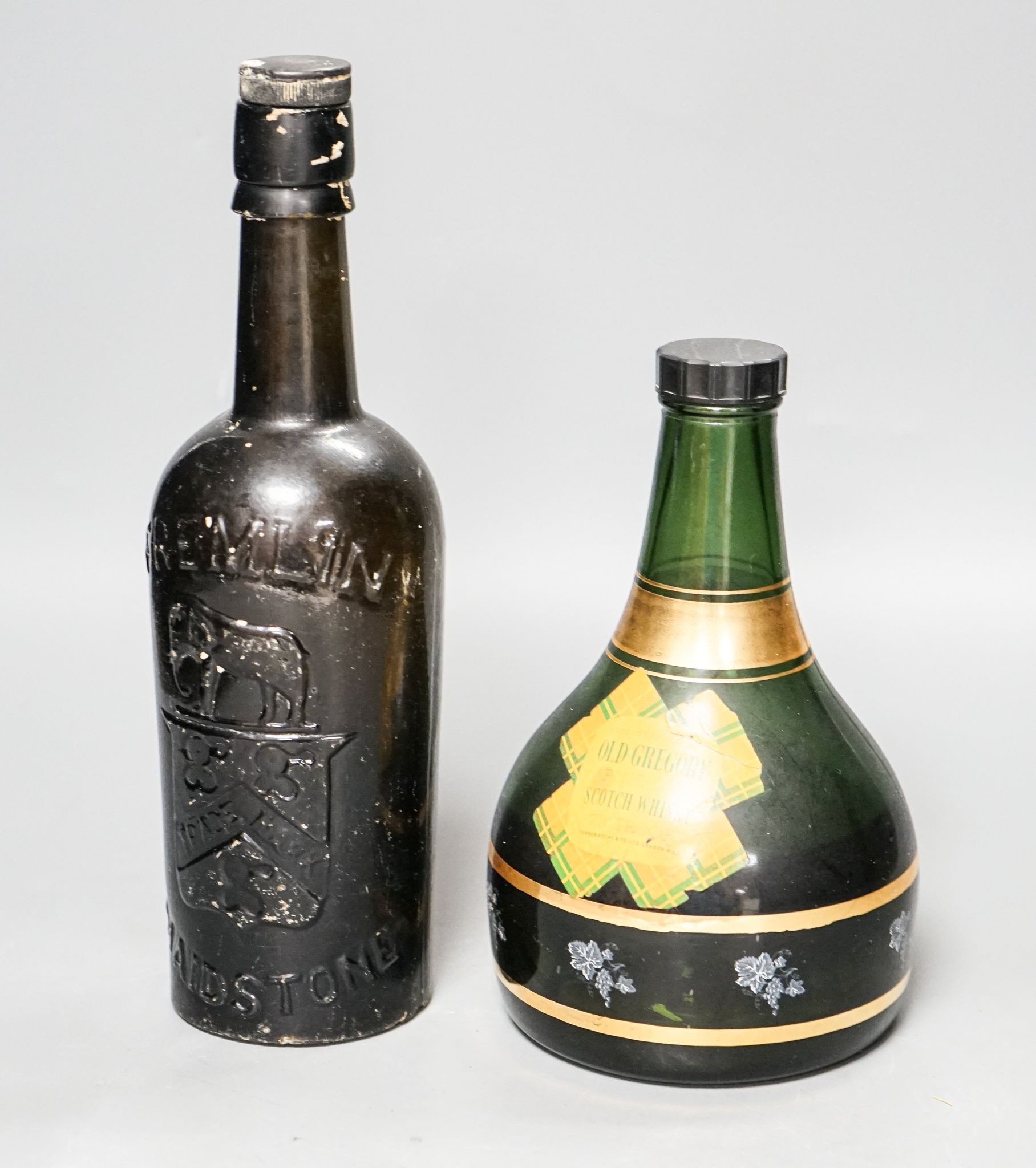 An old Fremlin of Maidstone beer bottle and an old Gregory Scotch whisky musical bottle
